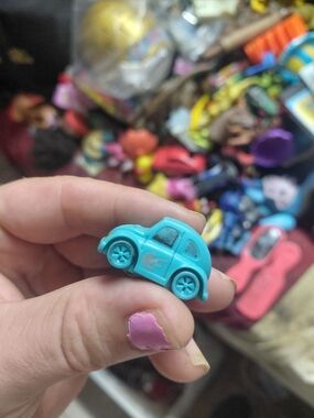 light-blue plastic toy Volkswagen Beetle (bug) car. [1] (https://boonsartshop.co